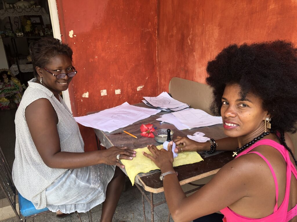 Color Photograph of Maritza Arango Montalvo and Mily sitting at a table.