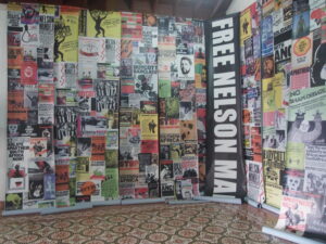 Photograph of a room filled with Nelson Mandela and anti-apartheid posters and flyers.