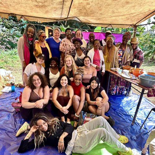 Contours participants pose together under a tent and smile